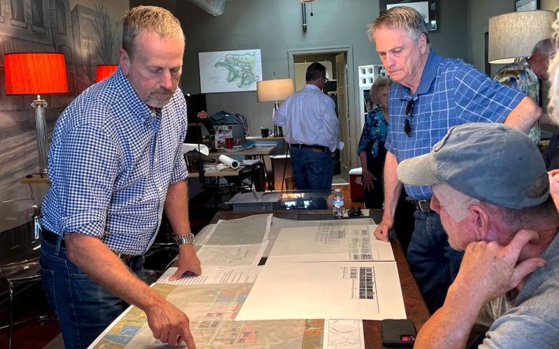 Lew Oliver, Councilman Terry Gladden and Brooks Garcia study map of Clarkesville at a Monday morning meeting. BRIAN WELLMEIER/Staff