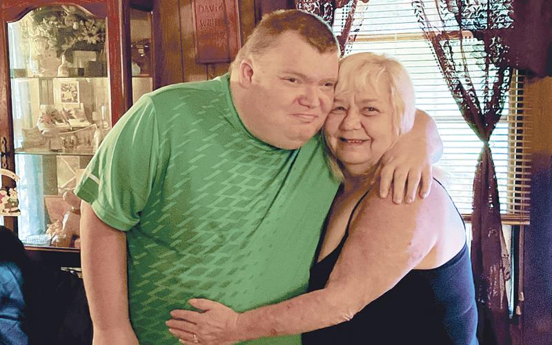 William Wells embraces his mother Judy following her close encounter with death. BRIAN WELLMEIER/Staff