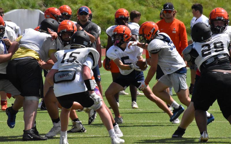 The Raiders got to work on all areas of their offense during the padded team camp. Here, Zeke Whittington reads the defense on an option play before keeping the ball and running for a nice gain. ISAIAH SMITH/Staff