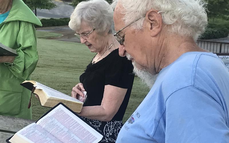 Sue Carnes and Dave Pelphrey read passages from the Book of Luke at Wednesday morning’s statewide reading event at the Habersham County Courthouse. MATTHEW OSBORNE/Staff