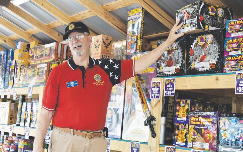 Edwin Hendricks, post commander of the American Legion Post 84, works the Phantom Fireworks stand in Cornelia to try to raise money for his organization on Thursday. CHAMIAN CRUZ/Staff