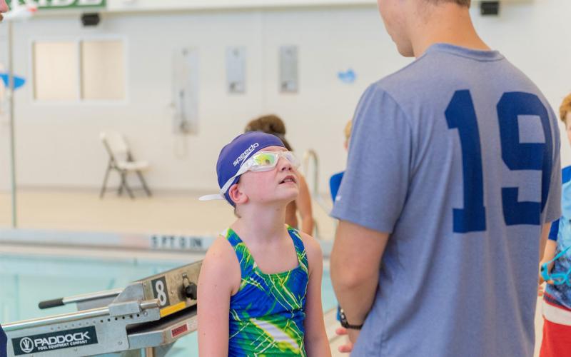 Caden Griffis gives instructions to a swimmer during camp at Tallulah Falls School last week. E. LANE GRESHAM/Special