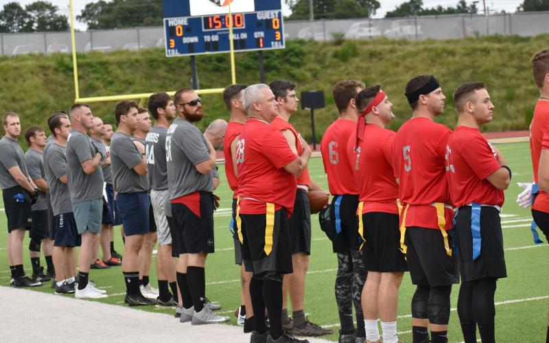 First responders participating in Saturday night’s Battle of the Heroes stand at attention before the beginning of the game. BRYANT ROCHE/Staff