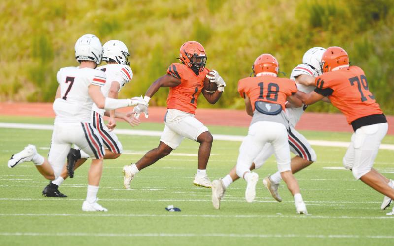 Habersham Central’s Simarcus Burney runs left during the Aug. 6 scrimmage with the help of blocks from Slade Dover (18) and B.J. Hodges (79). TOM ASKEW/Special