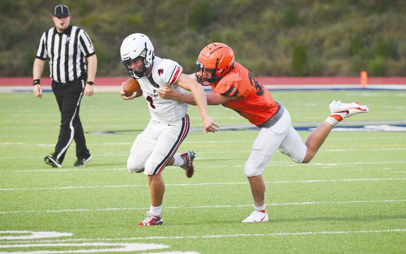 Habersham Central’s Blandon Grizzle gets a hold of a North Oconee ballcarrier during the scrimmage game on Aug. 6 at Raider Stadium. The Raiders travel to Madison County for the opening game tonight. TOM ASKEW/Special