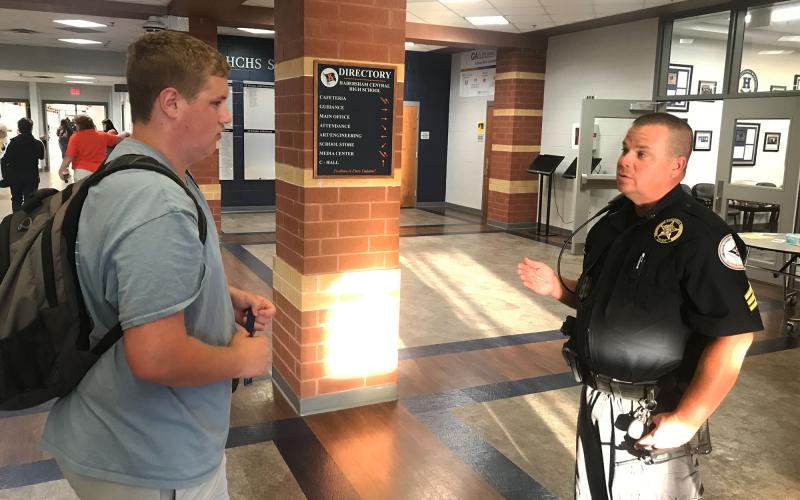 Habersham Central student Connor Williams (left) talks with Sgt. Griggs Wall before heading off to class. School Resource Officers will be much more active with students this year. MATTHEW OSBORNE/Staff