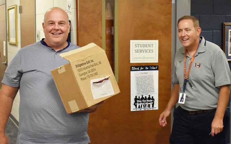 Principal Dr. Jonathan Stribling (right) greets teacher Matt Hudlow on Monday. MATTHEW OSBORNE/Staff