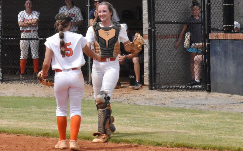 Habersham Central pitcher Hailey Wade congratulates her sister Taylor after a diving catch in foul territory against Rabun County on Aug. 22. CODY ROGERS/Staff