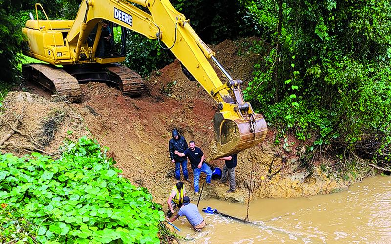 Demorest public works employees tend to a damaged pipe earlier this summer. Excessive rains have kept workers busy. BRYAN POPHAM/Submitted