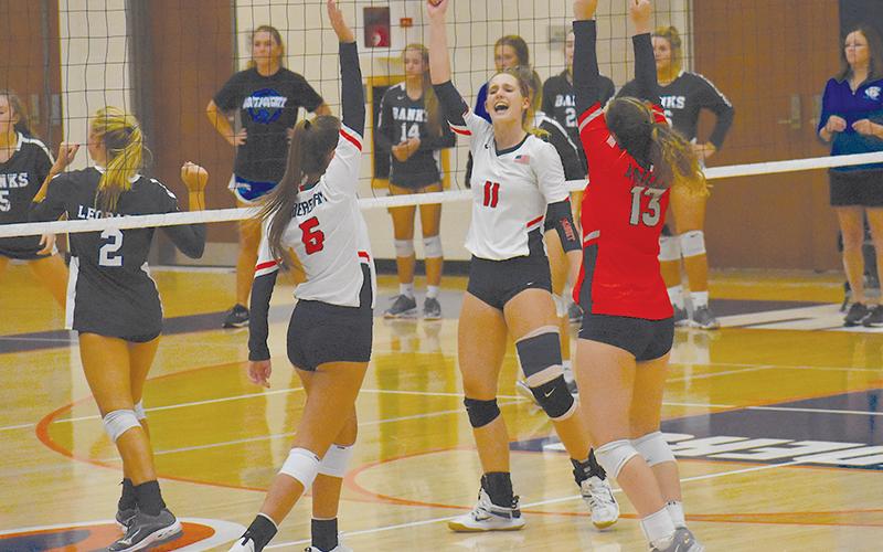 Habersham Central’s MaryKate Bush, Allie Church and Ansley McAllister celebrate a point during a home game against Banks County. CODY ROGERS/Staff