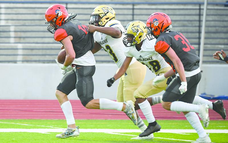 Habersham Central’s Noah Wilson breaks away from Apalachee tacklers after making a catch last Friday night. TOM ASKEW/Special