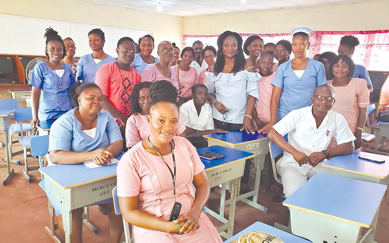 Dr. Marcella Davies (middle back with bracelet) stands with her students in Sierra Leone.