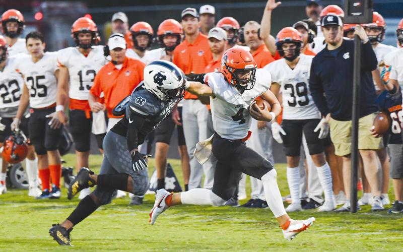 Habersham Central’s Carson Parker stiffarms a defender to pick up extra yards on Friday night against White County. TOM ASKEW/Special