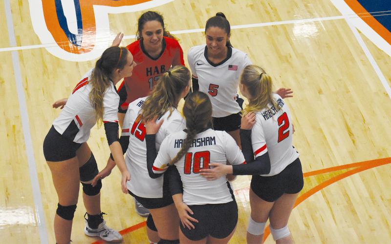 Habersham  Central’s  volleyball team gathers for a quick conference during a recent home game. CODY ROGERS/Staff