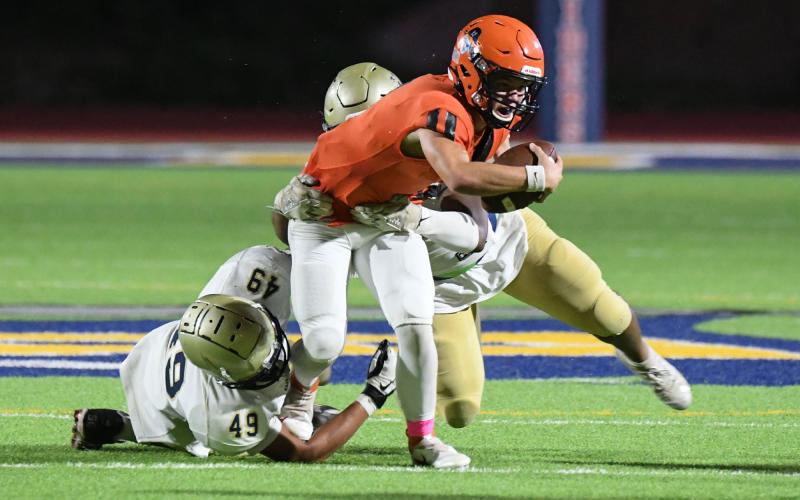 Habersham quarterback Carson Parker looks to break tackles on a scramble. TOM ASKEW/Special