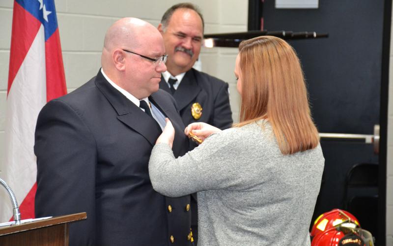 Habersham County Emergency Services Operations Chief Jason Davey gets his badge pinned by his wife Tenille in 2020 as former Chief Jeff Cain looks on. First responders have battled to keep their operations running at full strength amid an 18-month pandemic and a staffing crisis.