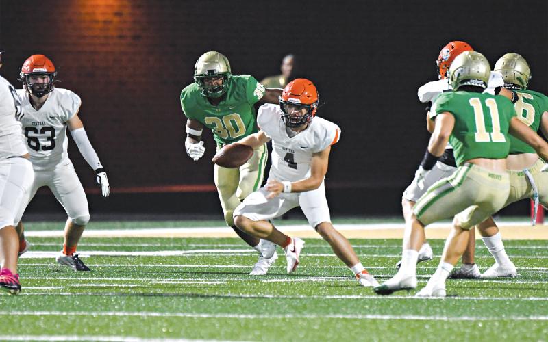 Carson Parker looks for running room on a scramble. TOM ASKEW/Special