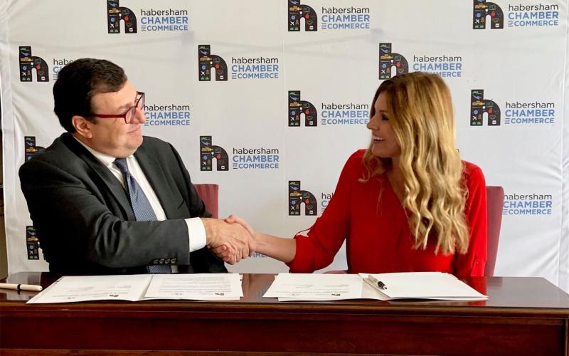 Latin American Chamber of Commerce President Alejandro Coss and Habersham Chamber President Mary Beth Horton shake after a new partnership is formed between the two chambers Monday. MARY BETH HORTON/Submitted