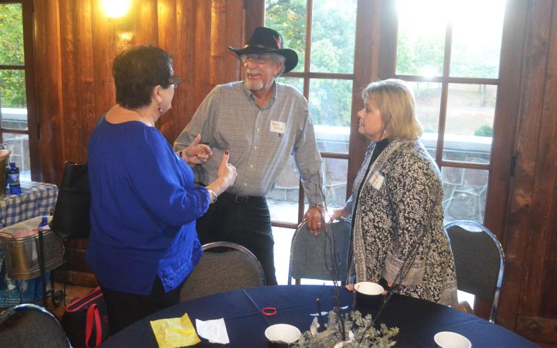 Bruce Demore catches up with Kay Smith Thompson just before the meal. MATTHEW OSBORNE/Staff