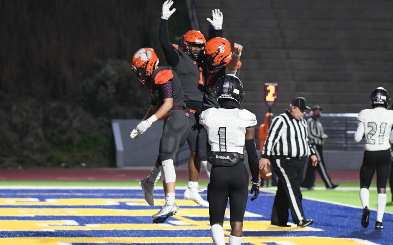 Habersham Central’s Caleb Wade (left) and Carson Parker (right) congratulate teammate Sirmarcus Burney on one of his three touchdowns. TOM ASKEW/Special