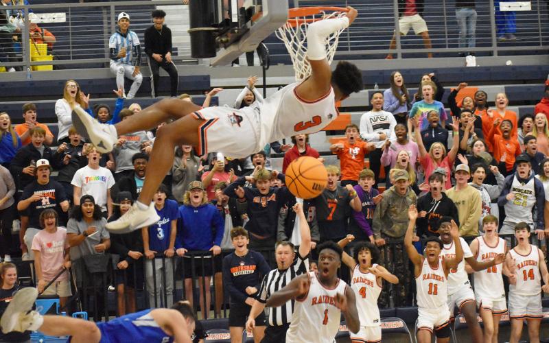 Habersham Central’s Malachi Dooley jams it home in the final seconds of Friday’s win over Banks County, to the delight of his teammates and home fans. CODY ROGERS/Staff