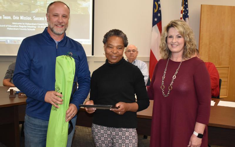 Marthe Freeman (middle) accepted the Service Above Self Award for October from Roland and school board member Kristy Dover. MATTHEW OSBORNE/Staff