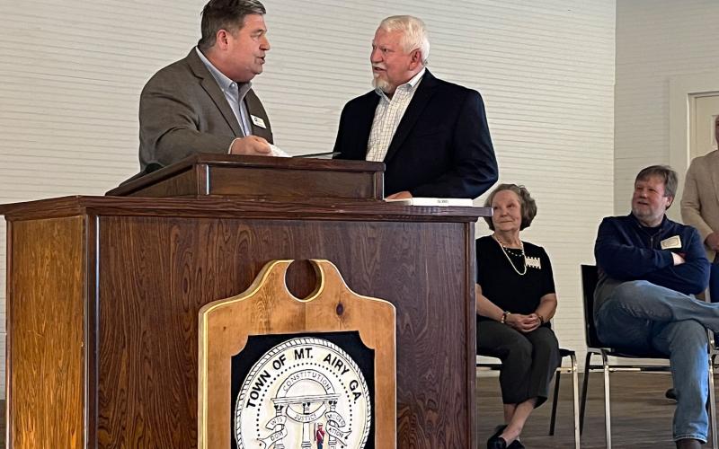 Mt. Airy Mayor Gary Morris (right) accepts a Lifetime Achievement Award from Georgia  Municipal Association representative Stan Brown  at Friday’s reception. MATTHEW OSBORNE/Staff