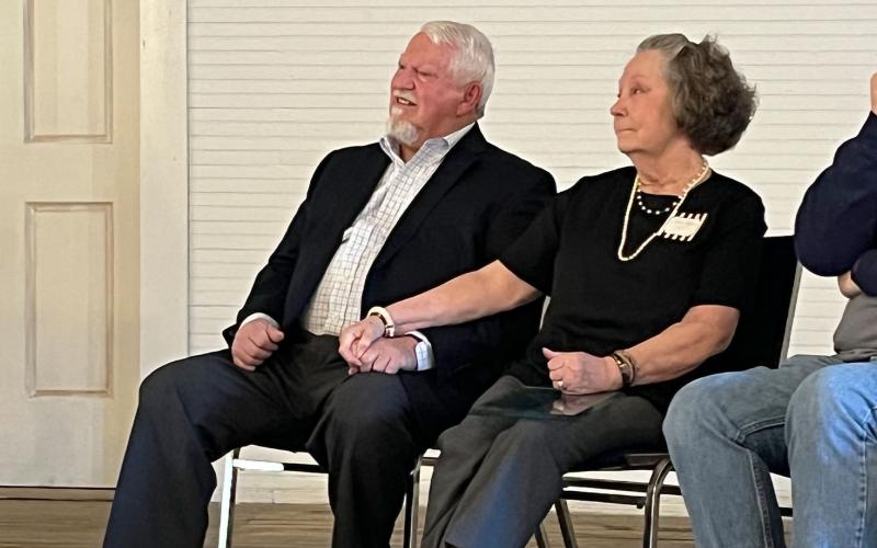 Mt. Airy Mayor Gary Morris listens to folks say nice things about him Friday at the Mt. Airy Schoolhouse building along with his wife Joan. MATTHEW OSBORNE/Staff