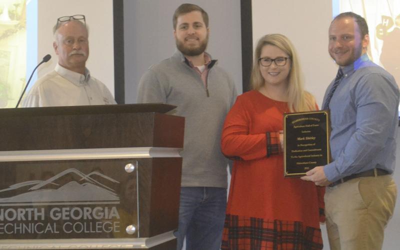 Mark Shirley (second from left) is recognized and inducted into the Habersham County Agriculture Hall of Fame for his work in agriculture by (from left) Jimmy Kowalsky of Habersham County Farm Bureau and Patrick Ledford (far right), Rotary-Vocational Service Director. BRIAN WELLMEIER/Staff