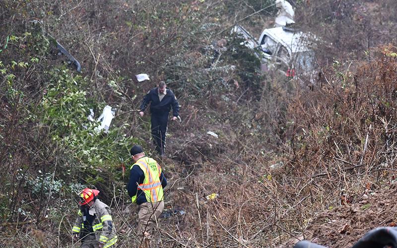Habersham County first responders assess the wreckage of a car that veered off Old Cleveland Road. MATTHEW OSBORNE/Staff