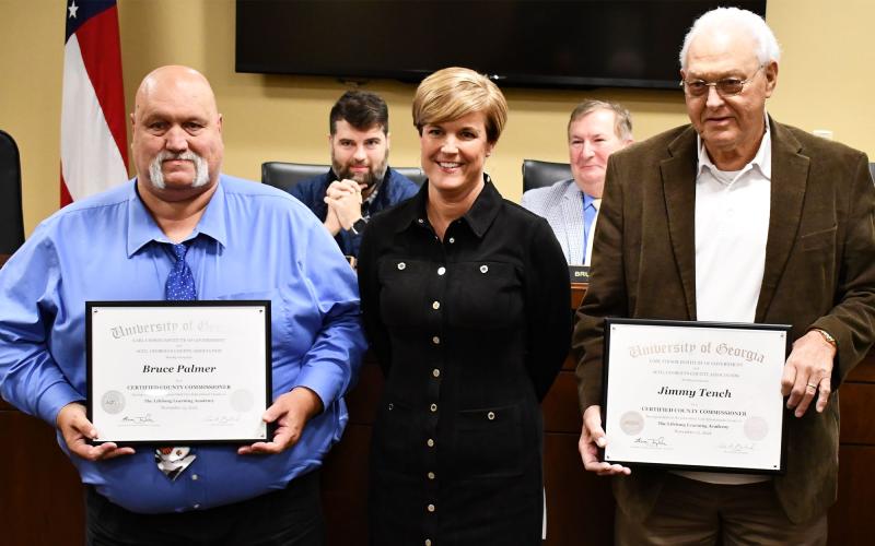 Commissioners Bruce Palmer (left) and Jimmy Tench recently became certified commissioners, and they were recognized Monday night by Interim County Manager Alicia Vaughn. MATTHEW OSBORNE/Staff