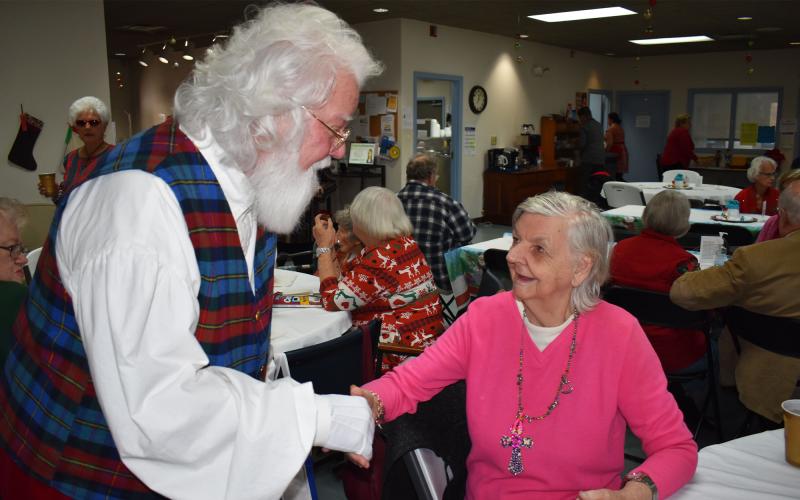 Billy Boyd embraces Senior Center client Helen Dove, who he’d brought a gift to on Thursday. BRIAN WELLMEIER/Staff