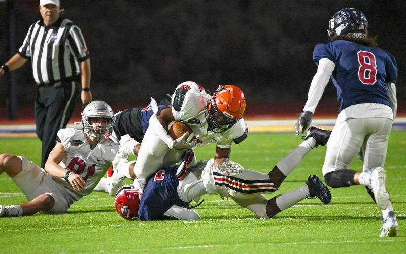Habersham Central’s Sirmarcus Burney (center) battles through many defenders on a first down run. ZACHARY TAYLOR/Special