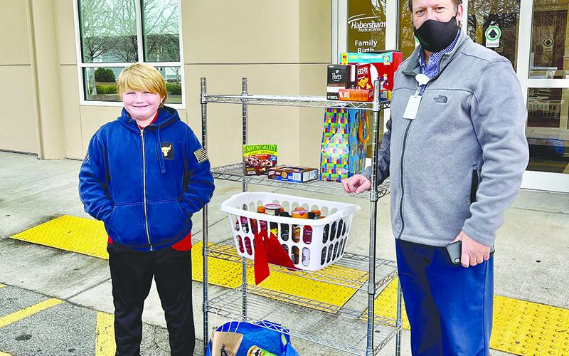Max Daniel (left) delivers goods he gathered for donation to healthcare workers at Habersham Medical Center, where they were accepted by Matthew Miles. TRICIA HISE/Submitted