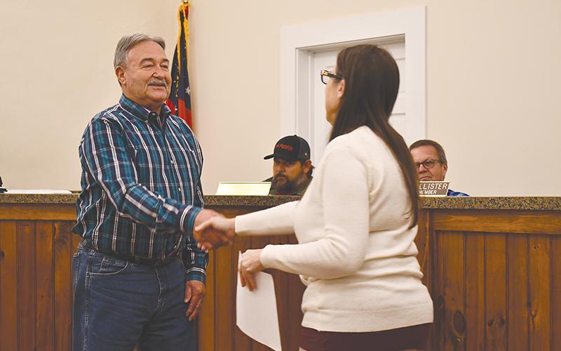 Mt. Airy Mayor Ray McAllister shakes hands with clerk Sheri Berrong after being sworn in Monday night.