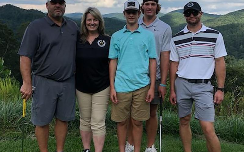 Shane Dover is shown with his family - wife Kristie and sons Sawyer, Sutton and Slade.