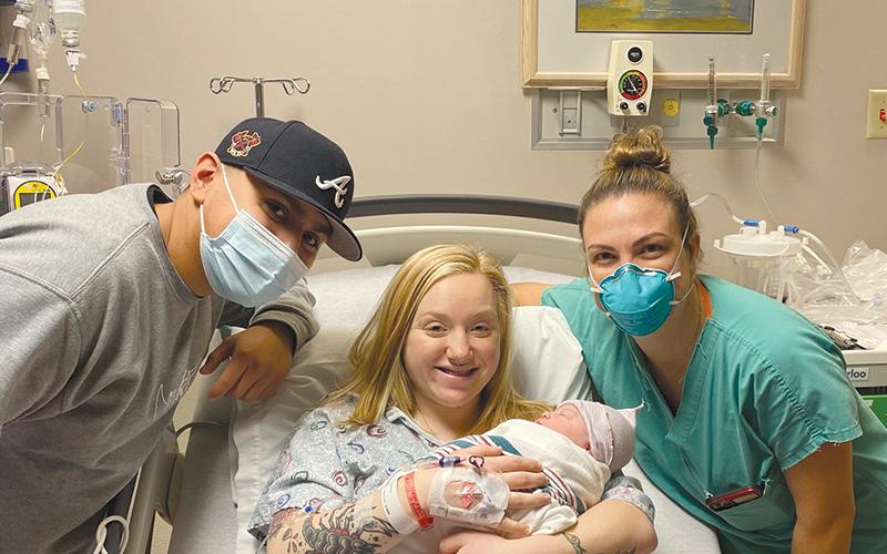 Daelynn Gordon (middle) holds her baby girl Mia with father Alex Ramirez and midwife Emily Jones at Habersham Medical Center on Jan. 1. MATTHEW MILES/Submitted