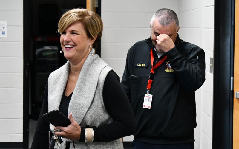 Retiring Emergency Services Director Chad Black got a surprise party on his way out Friday, attended by many county staff, officials and fellow first responders. He is shown above as he walks into the trap with County Manager Alicia Vaughn at the Ruby Fulbright Aquatic Center. MATTHEW OSBORNE/Staff