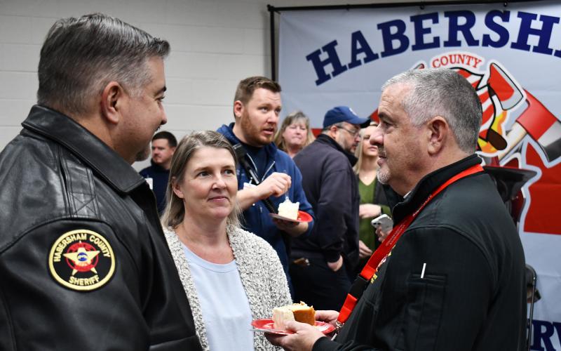 Chad Black (right) talks with Habersham Sheriff’s Col. Murray Kogod and IT Director Tracy Williamson at his surprise party Friday. MATTHEW OSBORNE/Staff