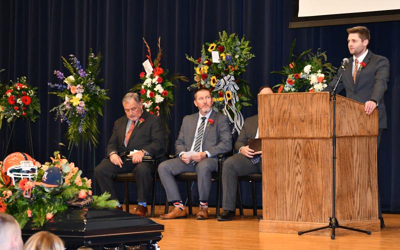 Sawyer  Dover  eulogizes  his father Shane at  Saturday’s memorial service at Habersham Central High School as the Rev. Doug Porter,  Coach Benji Harrison and Dr. Brian James  (obscured) listen in. MATTHEW OSBORNE/Staff