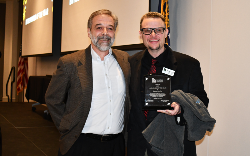 Guy Ramos (left) presents the award for Ambassador of the Year to Randall Roy Fry. BRIAN WELLMEIER/Staff