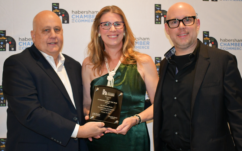 Sidney Roland III (left) presents the award for Entrepreneur of the Year to Jay and Melissa Reeder. BRIAN WELLMEIER/Staff