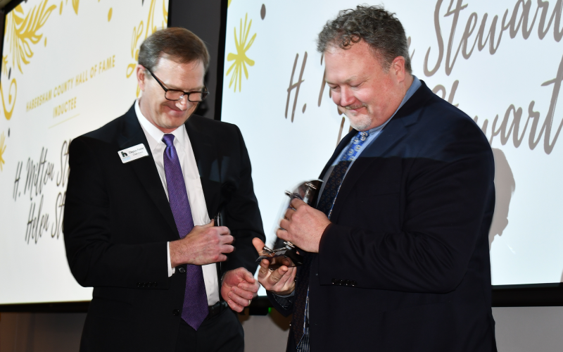 This year’s Habersham County Hall of Fame Inductees were H. Milton Stewart Sr and Helen Stewart, and the award was accepted by their grandson Chris Swanson (right) as presented by Clayton Foster. BRIAN WELLMEIER/Staff