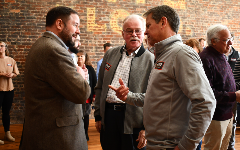 Cornelia Mayor John Borrow and Tom Hensley speak with Gov. Brian Kemp. BRIAN WELLMEIER/Staff