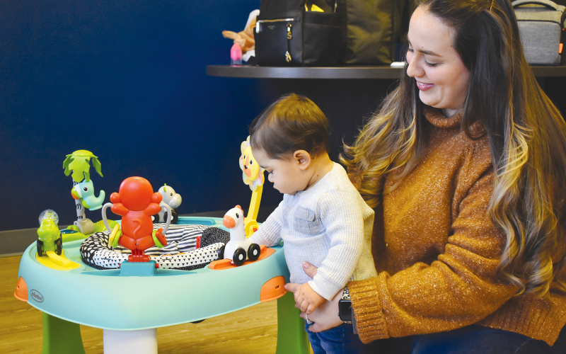 Natasha Rivera tries to keep her son, Gabriel, entertained while working as a full-time office manager. Rivera, who is able to bring her son to work with her, said it’s hard to juggle her responsibilities at work while trying to keep an eye on her son. AMARIS E. RODRIGUEZ/Staff