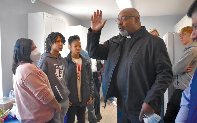 Tinisha Combs, Enzo Combs and Emyrie Combs watch as Pastor Hawks of Mount Zion Baptist Church delivers a prayer. BRIAN WELLMEIER/Staff