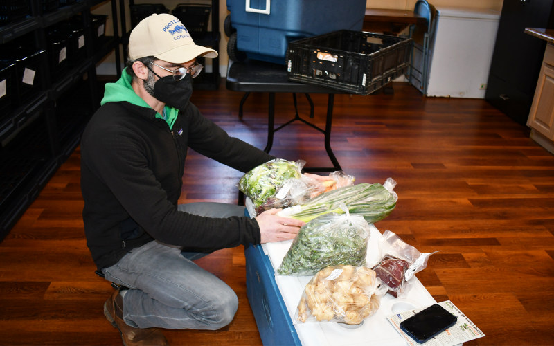 Andrew Linker handles fresh produce at Locally Grown’s Clarkesville location. BRIAN WELLMEIER/Staff