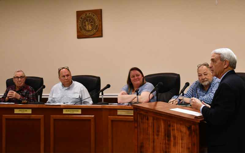 Partnership Habersham Director Charlie Fiveash (right) makes his pitch Monday to Baldwin City Council to stay in business together. BRIAN WELLMEIER/Staff