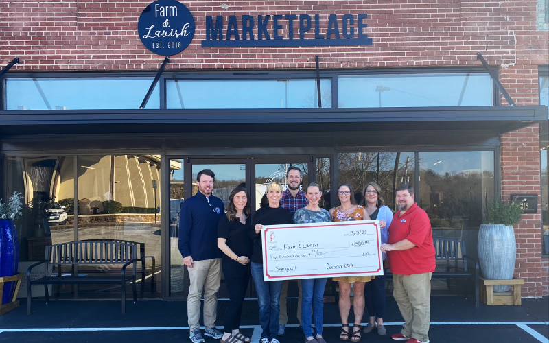 Farm &amp; Lavish Marketplace receives its check with (from left) Brennt Cody, Cagney Meads, Brenda Williams, Heath Barrett, Alice Dover, Jessie Owensby, Sarah Higgins, and Jason Tanner attending. CITY OF CORNELIA/Submitted
