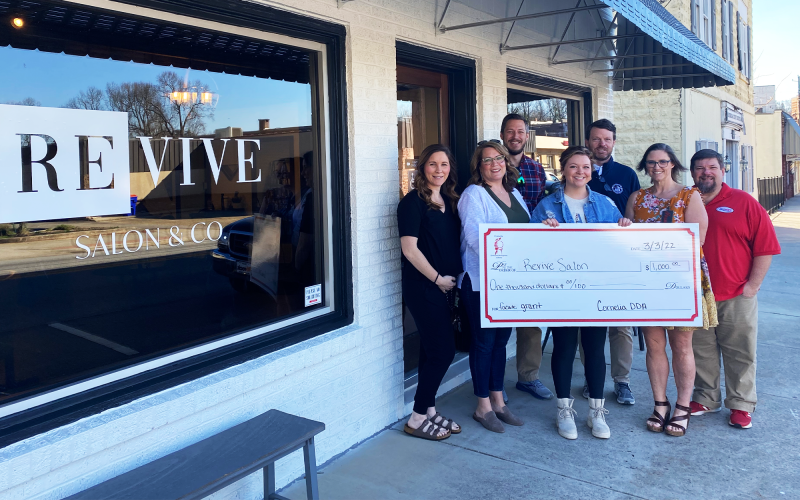 Revive Salon receives its check with (from left) Cagney Meads, Sarah Higgins, Heath Barrett, Jessie Palmer, Brentt Cody, Jessie Owensby, and Jason Tanner attending. CITY OF CORNELIA/Submitted